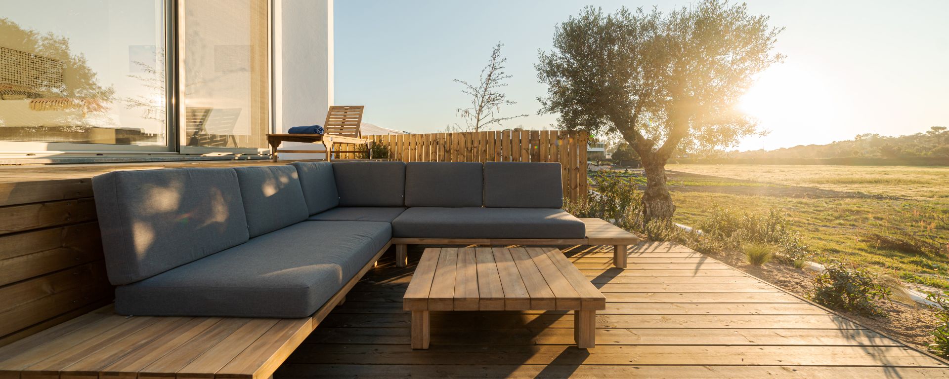 Relax corner with cushions on deck in modern villa terrace.