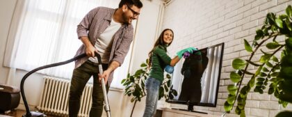 Man and woman couple cleaning their home