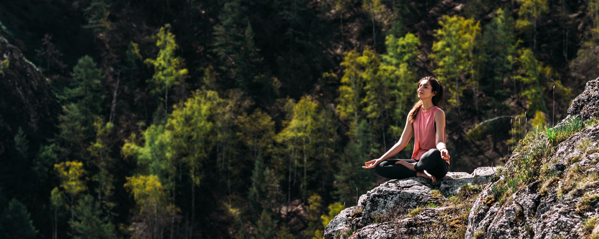 Woman doing yoga in the mountains.